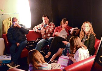 A group sitting on couch and listening at Roane Song