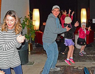 Dancing audience group at a Roane Song event